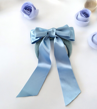 Load image into Gallery viewer, Pale Blue Satin Bow Headband Fascinator, on a Sinamay Halo Base, with tails