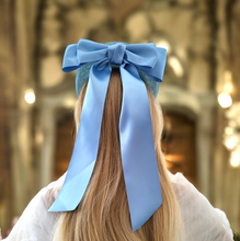 Load image into Gallery viewer, Pale Blue Satin Bow Headband Fascinator, on a Sinamay Halo Base, with tails